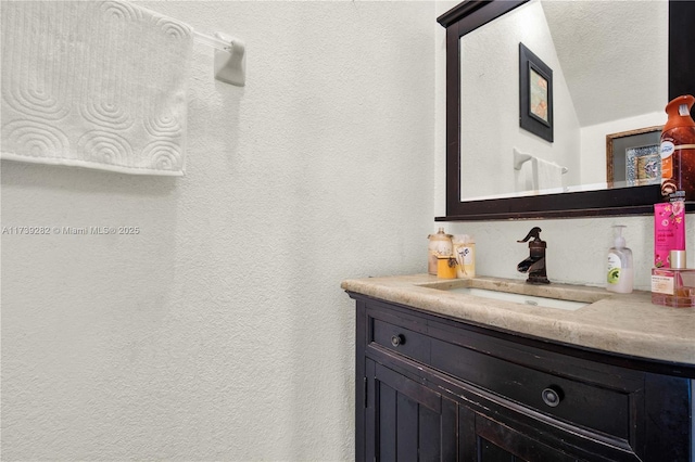 bathroom with vanity and a textured ceiling