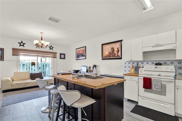 kitchen with white electric range, sink, white cabinetry, hanging light fixtures, and a center island with sink