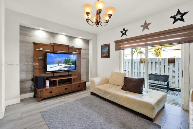 living room featuring a notable chandelier and light hardwood / wood-style floors