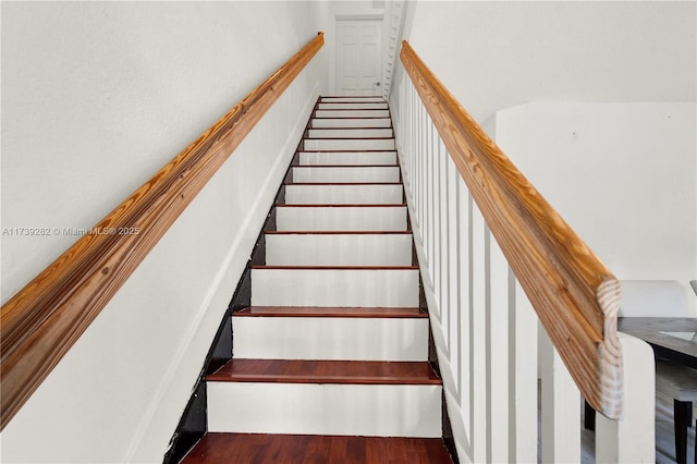 staircase featuring wood-type flooring