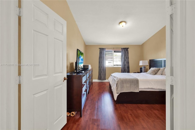 bedroom with dark hardwood / wood-style floors