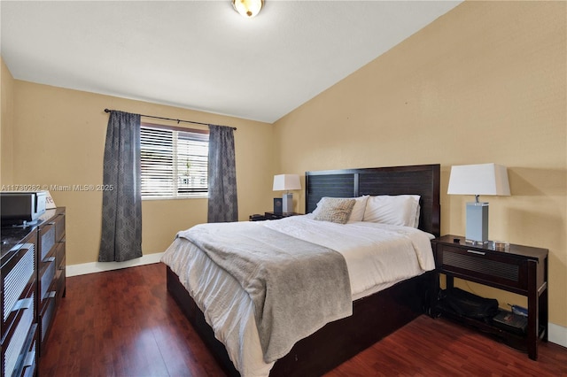 bedroom featuring lofted ceiling and dark hardwood / wood-style flooring