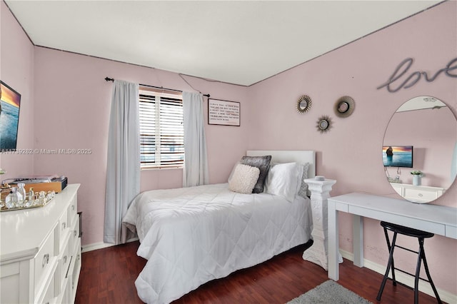 bedroom with dark hardwood / wood-style flooring