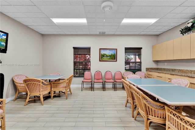 dining room featuring a drop ceiling