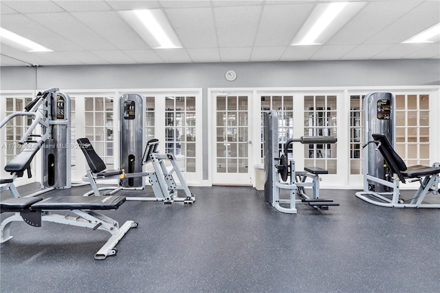 gym featuring french doors and a paneled ceiling