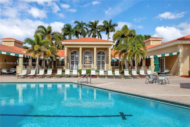 view of swimming pool featuring an outdoor structure and a patio