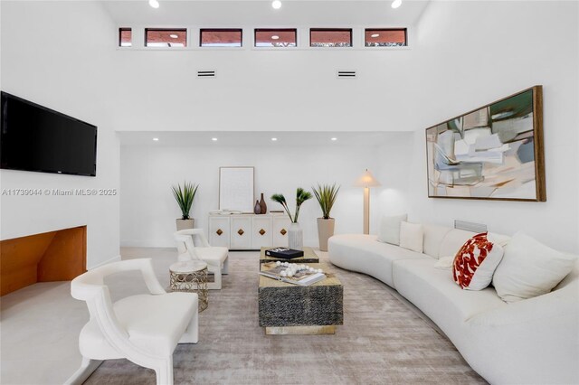 living room featuring a towering ceiling