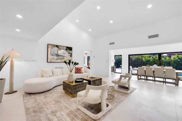 living area with high vaulted ceiling, recessed lighting, and visible vents