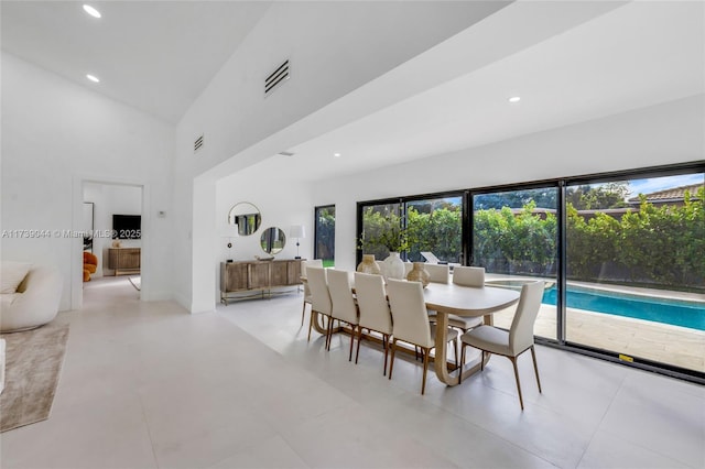 dining area featuring high vaulted ceiling, recessed lighting, and visible vents