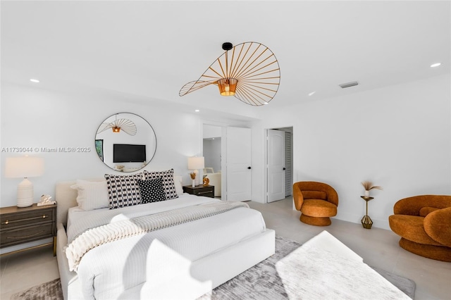 bedroom with finished concrete flooring, visible vents, a closet, and recessed lighting