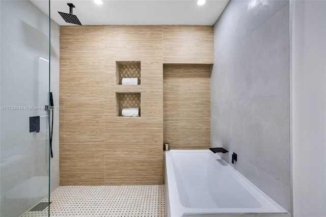 bathroom with recessed lighting, a garden tub, tile walls, and walk in shower