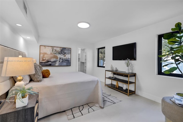 bedroom featuring baseboards, concrete floors, visible vents, and recessed lighting