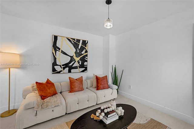 living area with light colored carpet and baseboards