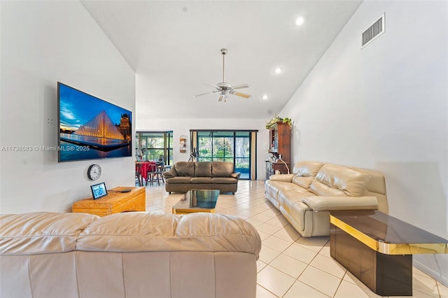 tiled living room featuring high vaulted ceiling and ceiling fan