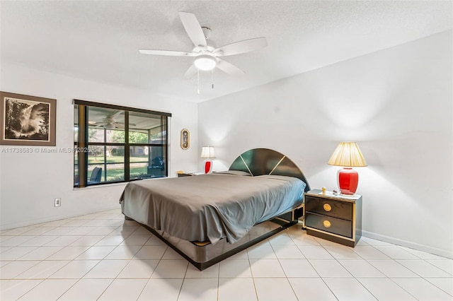 tiled bedroom featuring ceiling fan and a textured ceiling