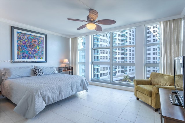 tiled bedroom with ceiling fan, multiple windows, floor to ceiling windows, and ornamental molding