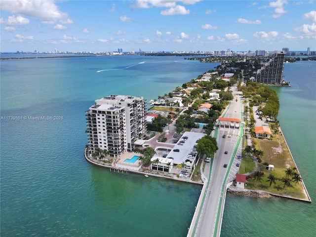 birds eye view of property featuring a view of city and a water view