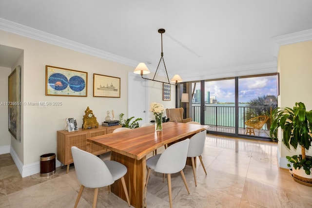 dining space with an inviting chandelier, a wall of windows, and ornamental molding