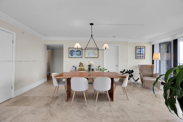 dining area with baseboards and crown molding