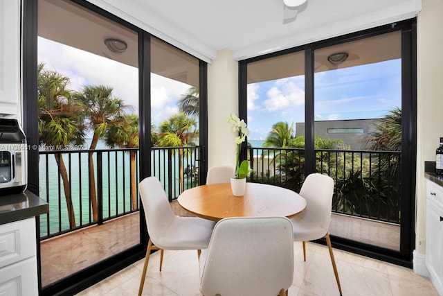 801 N Venetian Dr Unit 201, Miami, FL 33139 - sunroom with a wall of windows and marble finish flooring