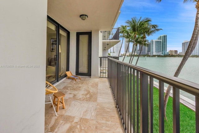 balcony with a water view and a city view