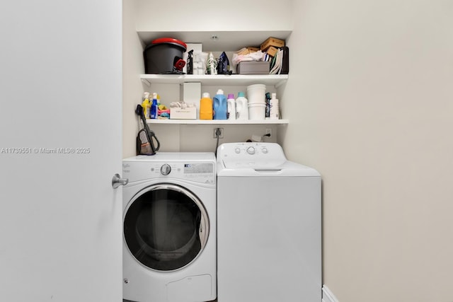 clothes washing area with laundry area and washer and clothes dryer