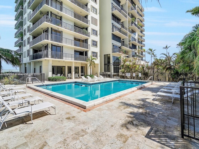 pool featuring a patio area and fence