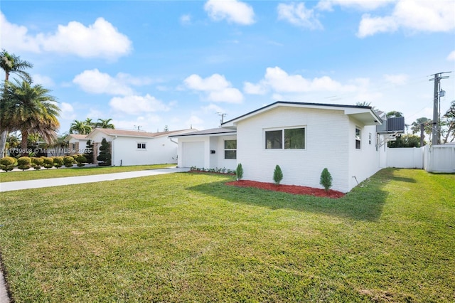 view of front facade with a garage, driveway, a front lawn, and fence