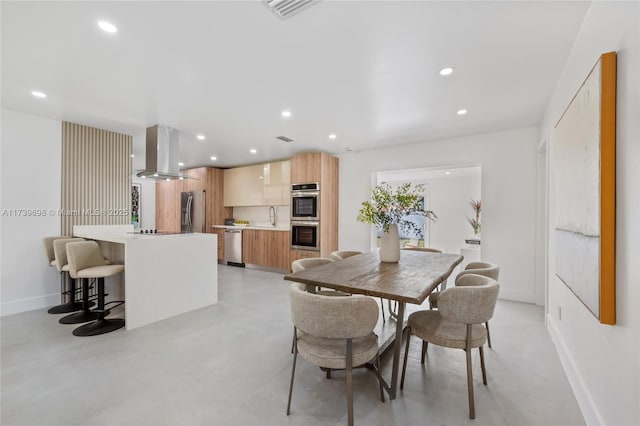 dining area featuring finished concrete floors, baseboards, visible vents, and recessed lighting