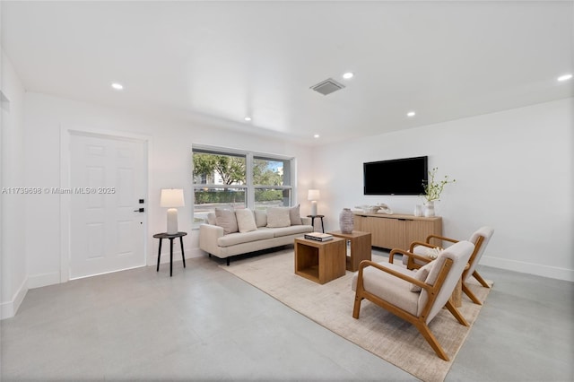 living room featuring baseboards, visible vents, concrete flooring, and recessed lighting