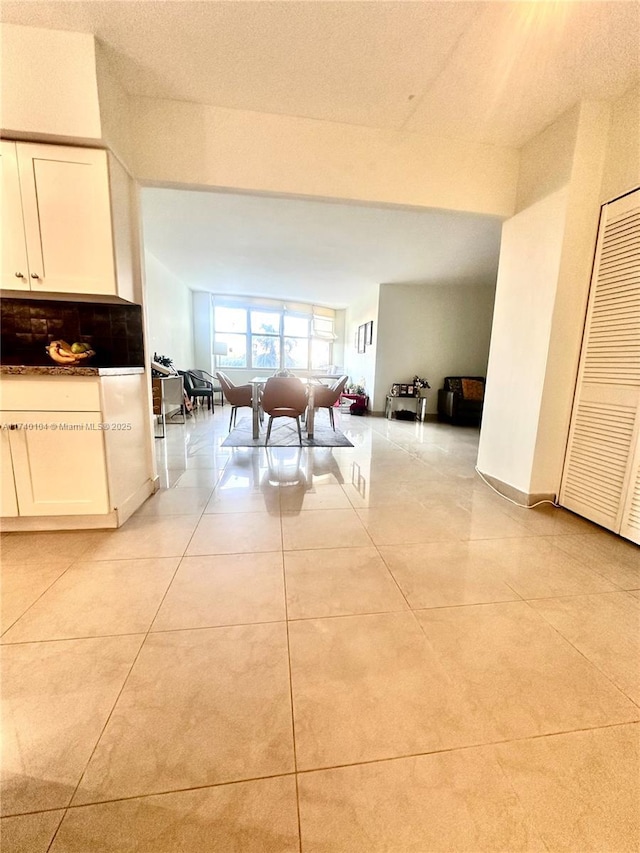 unfurnished dining area featuring light tile patterned floors