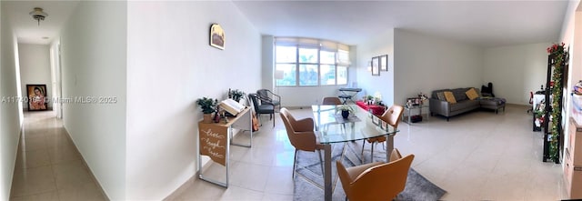 dining space featuring light tile patterned flooring