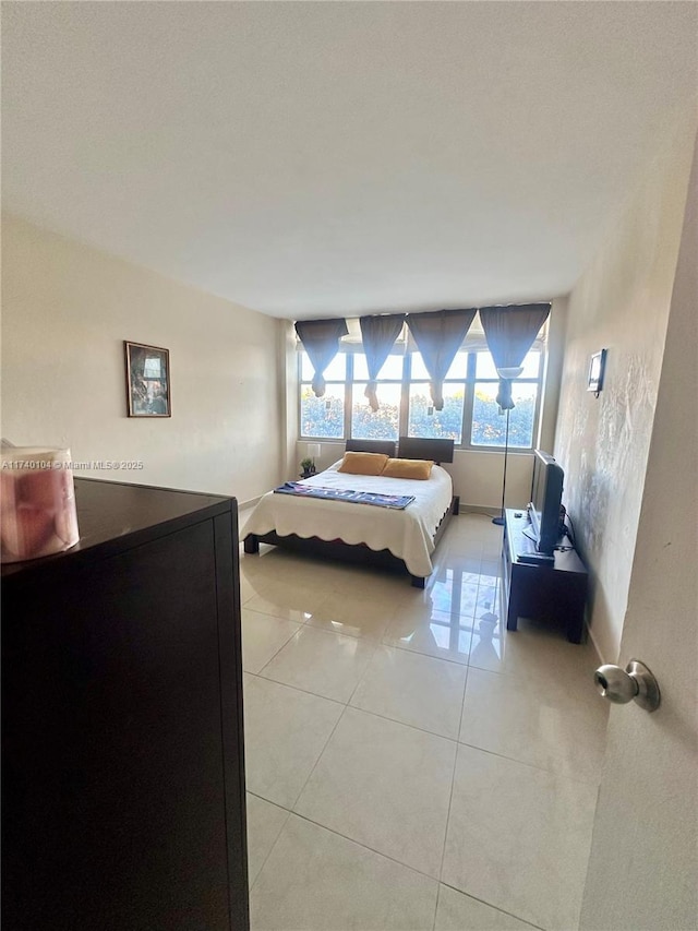 bedroom with light tile patterned floors