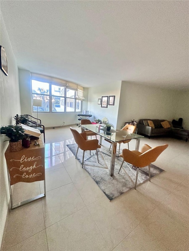 tiled living room featuring a textured ceiling