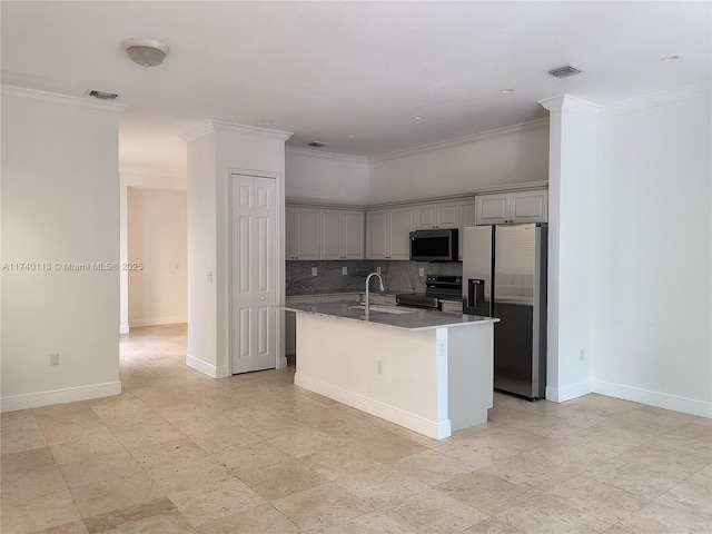 kitchen featuring visible vents, gray cabinets, a sink, appliances with stainless steel finishes, and decorative backsplash