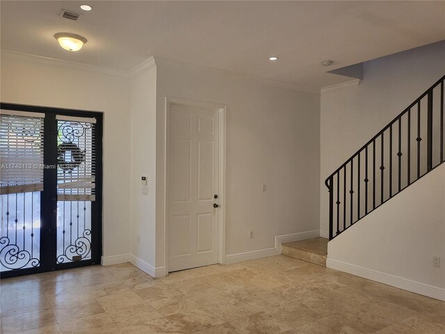 spare room featuring crown molding