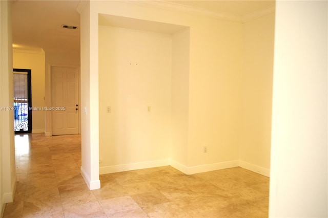 unfurnished room with visible vents, baseboards, and ornamental molding