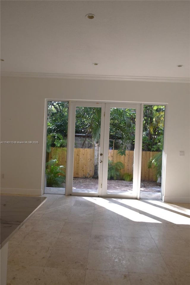 unfurnished room featuring baseboards and ornamental molding