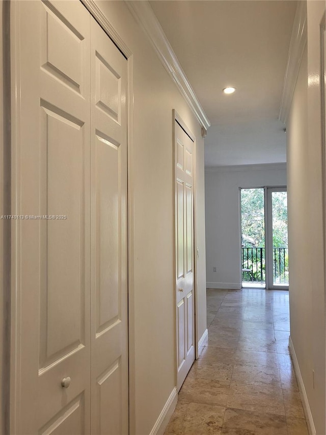 hallway featuring recessed lighting, crown molding, and baseboards