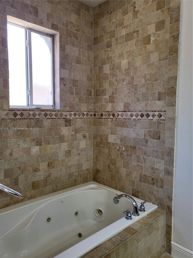 bathroom with tiled tub