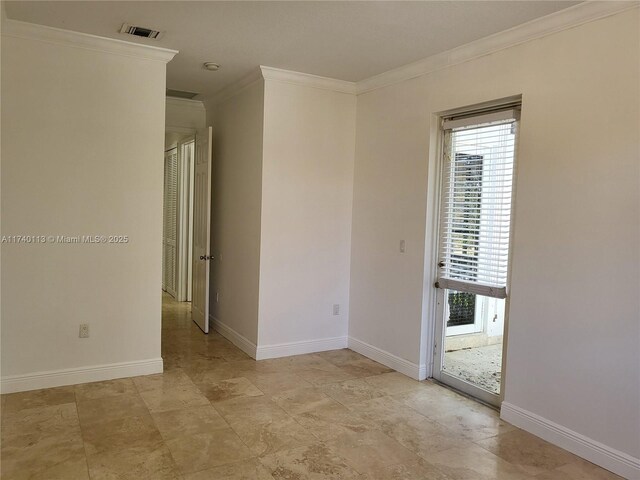 spare room with ornamental molding and a textured ceiling