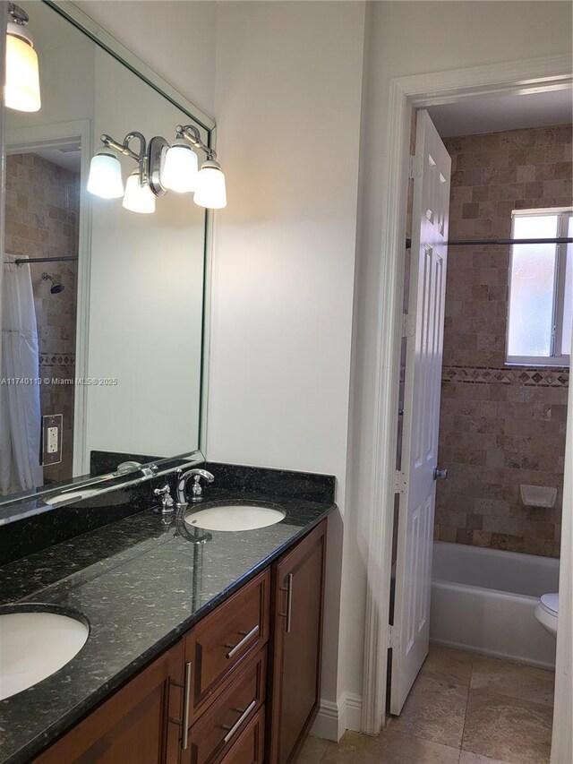 full bathroom featuring vanity, shower / bath combination with curtain, and toilet