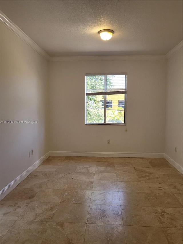 unfurnished room with baseboards, a textured ceiling, and crown molding