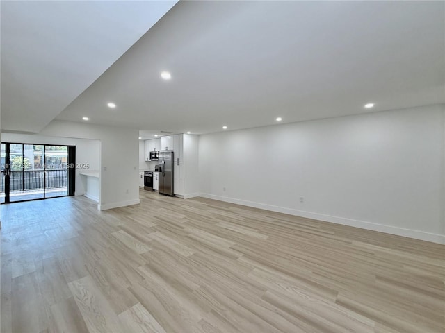 unfurnished living room featuring light wood-type flooring