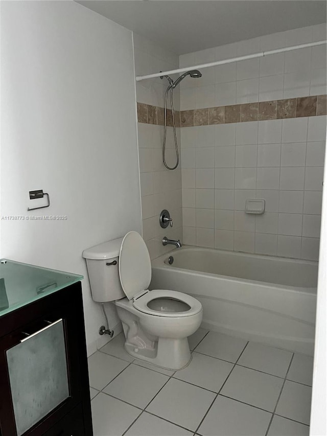 full bathroom with vanity, toilet, tiled shower / bath combo, and tile patterned flooring