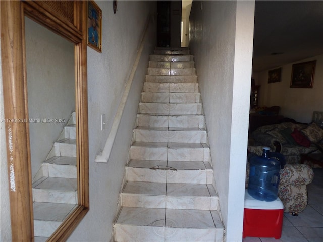 staircase featuring tile patterned floors