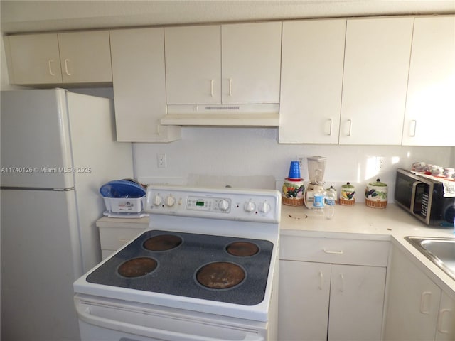 kitchen with white cabinetry, white appliances, and sink