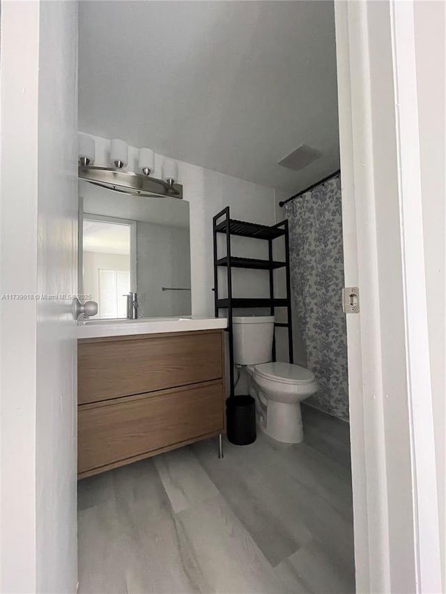 bathroom with vanity, toilet, and a shower with curtain