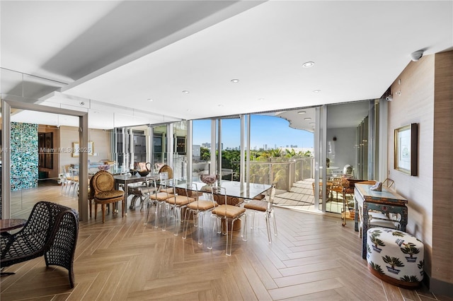 dining space with floor to ceiling windows and light parquet floors