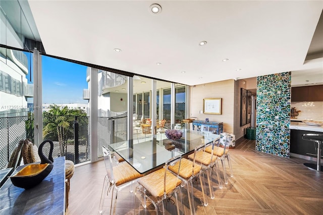 dining area featuring floor to ceiling windows and parquet flooring